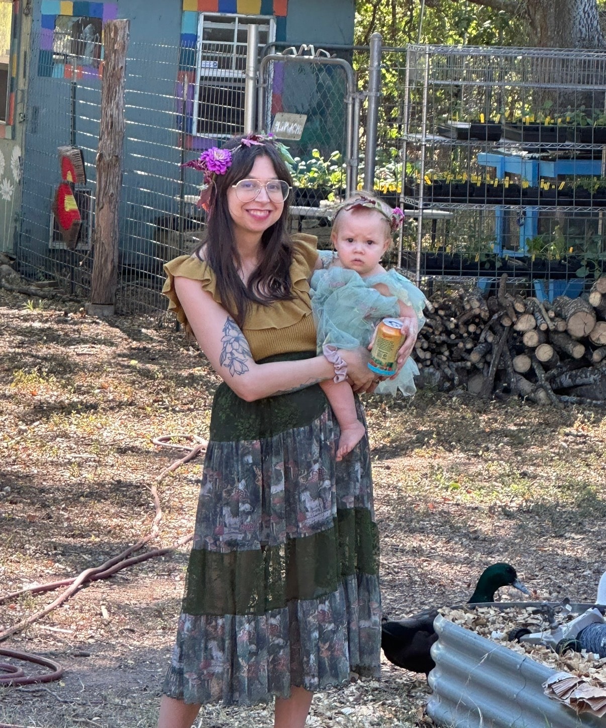Founder of Wilder Roots Collective with her youngest at a garden